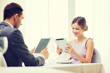 Image showing couple with menus on tablet pc at restaurant