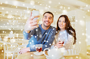 Image showing couple taking smartphone selfie at cafe restaurant