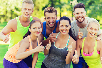 Image showing group of happy sporty friends showing thumbs up