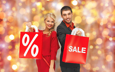 Image showing couple with sale sign on shopping bags