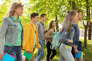 Image showing group of happy teenage students walking outdoors