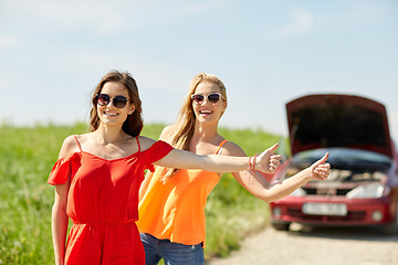 Image showing women with broken car hitchhiking at countryside