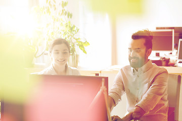 Image showing happy creative team with computer in office