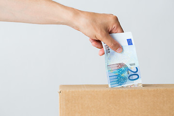 Image showing man putting euro money into donation box