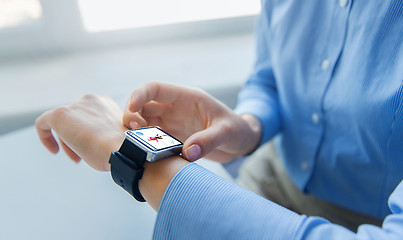 Image showing close up of hands with fitness app on smart watch