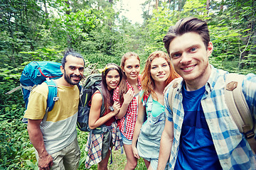 Image showing friends with backpack taking selfie in wood