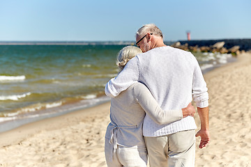 Image showing close up of happy senior couple hugging on beach