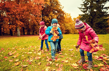 Image showing group of children collecting leaves in autumn park