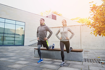 Image showing couple doing lunge exercise on city street