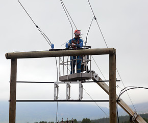 Image showing Electrician working at a power transmission line construction