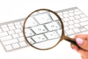 Image showing Laptop with a magnifying glass