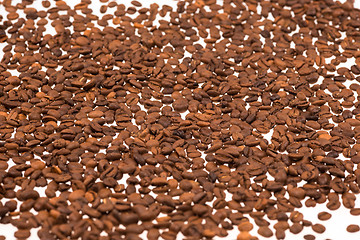 Image showing Black coffee beans on white table,