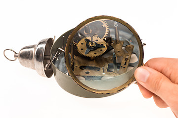 Image showing The male hand with magnifier and clockwork