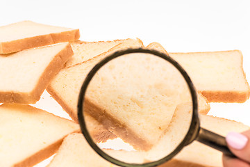 Image showing View through a magnifying glass to toast bread on the table. Wheat.