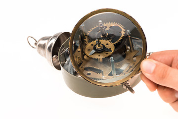 Image showing The male hand with magnifier and clockwork