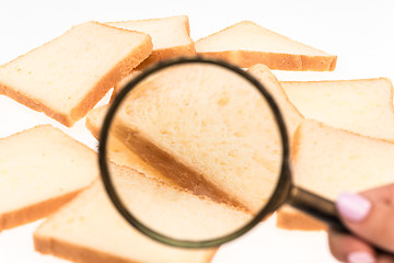 Image showing View through a magnifying glass to toast bread on the table. Wheat.