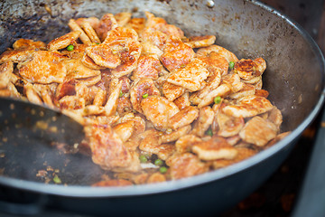 Image showing close up of meat in wok pan at street market