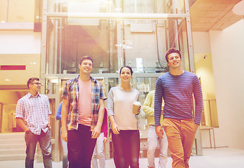 Image showing group of smiling students with paper coffee cups