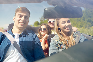 Image showing happy friends driving in cabriolet car