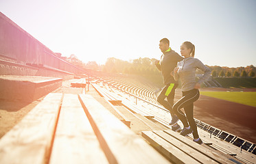 Image showing happy couple running upstairs on stadium