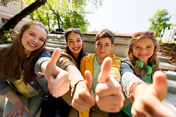 Image showing teenage friends or students showing thumbs up