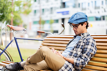 Image showing man with notebook or diary writing on city street