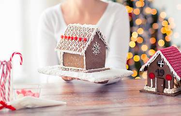 Image showing close up of woman showing gingerbread house