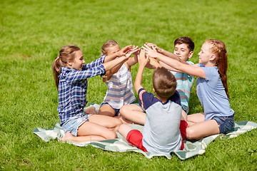 Image showing group of happy kids putting hands together