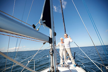 Image showing senior couple hugging on sail boat or yacht in sea