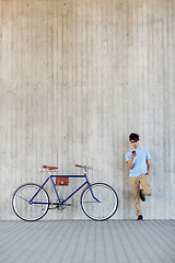 Image showing man with smartphone and fixed gear bike on street