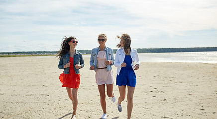 Image showing group of smiling women in sunglasses on beach