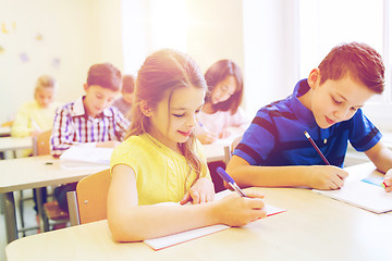 Image showing group of school kids writing test in classroom