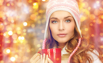 Image showing young woman in winter clothes with tea cup