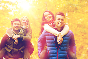 Image showing smiling friends having fun in autumn park