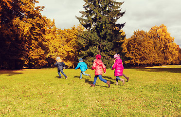 Image showing group of happy little kids running outdoors