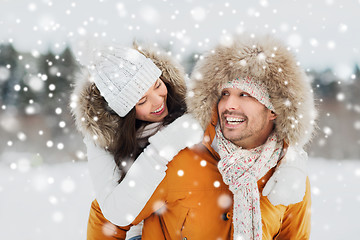 Image showing happy couple having fun over winter background