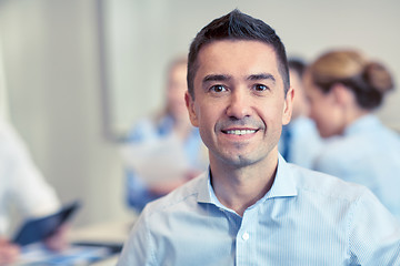 Image showing group of smiling businesspeople meeting in office