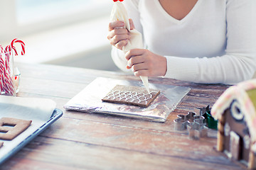 Image showing close up of woman making gingerbread houses