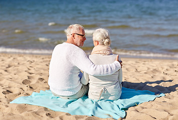 Image showing happy senior couple hugging on summer beach