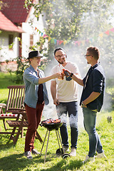 Image showing friends drinking beer at summer barbecue party