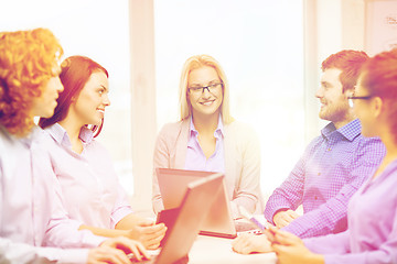 Image showing smiling team with laptop and table pc computers