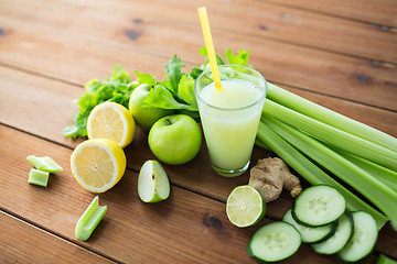 Image showing close up of glass with green juice and vegetables