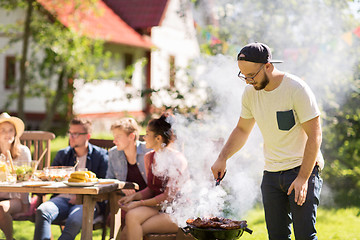 Image showing man cooking meat on barbecue grill at summer party