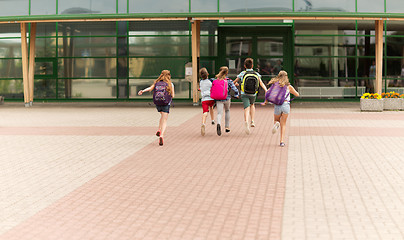 Image showing group of happy elementary school students running