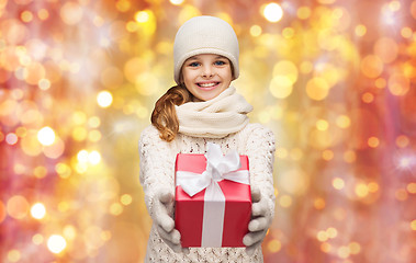 Image showing happy girl in hat, scarf and gloves with gift box