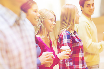 Image showing group of smiling students with paper coffee cups