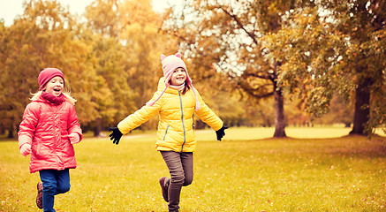 Image showing group of happy little girls running outdoors