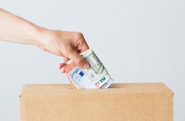 Image showing man putting euro money into donation box