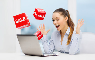 Image showing surprised businesswoman with laptop and sale signs