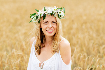 Image showing happy young woman in flower wreath on cereal field